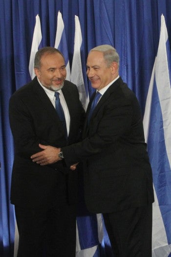 Israeli Prime Minister Benjamin Netanyahu, right, of Likud and Foreign Minister Avigdor Liberman of Yisrael Beiteinu holding a joint news conference announcing that their two parties are joining forces ahead of the upcoming Israeli general elections, Oct. 25, 2012. (Miriam Alster/Flash90)
