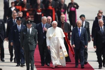 Pope Benedict XVI is flanked by Israeli Prime Minister Benjamin Netanyahu, left, and President Shimon Peres upon his arrival at Ben Gurion International Airport on May 11, 2009.
(Flash90 / JTA)