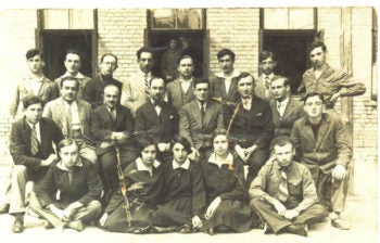 The fate of three of the 15 students in the first graduating class of Grodno's Tarbut Gymnasium in 1930 (pictured with six of their teachers and the principal) remains a mystery. (Courtesy Ruth Marcus)