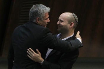 Yesh Atid party leader Yair Lapid hugging Jewish Home party chief Naftali Bennett following Lapid's first speech at the Knesset, Feb. 11, 2013.
(Miriam Alster/Flash90/JTA)