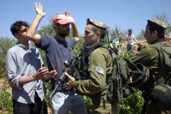 Israeli soldiers scuffling with Palestinians during a demonstration near the West Bank village of Beit Omar, Aug. 13, 2011. Some analysts have warned that a U.N. vote on Palestinian statehood could set off a new wave of Palestinian-Israeli violence. (Najeh Hashlamoun / Flash 90)