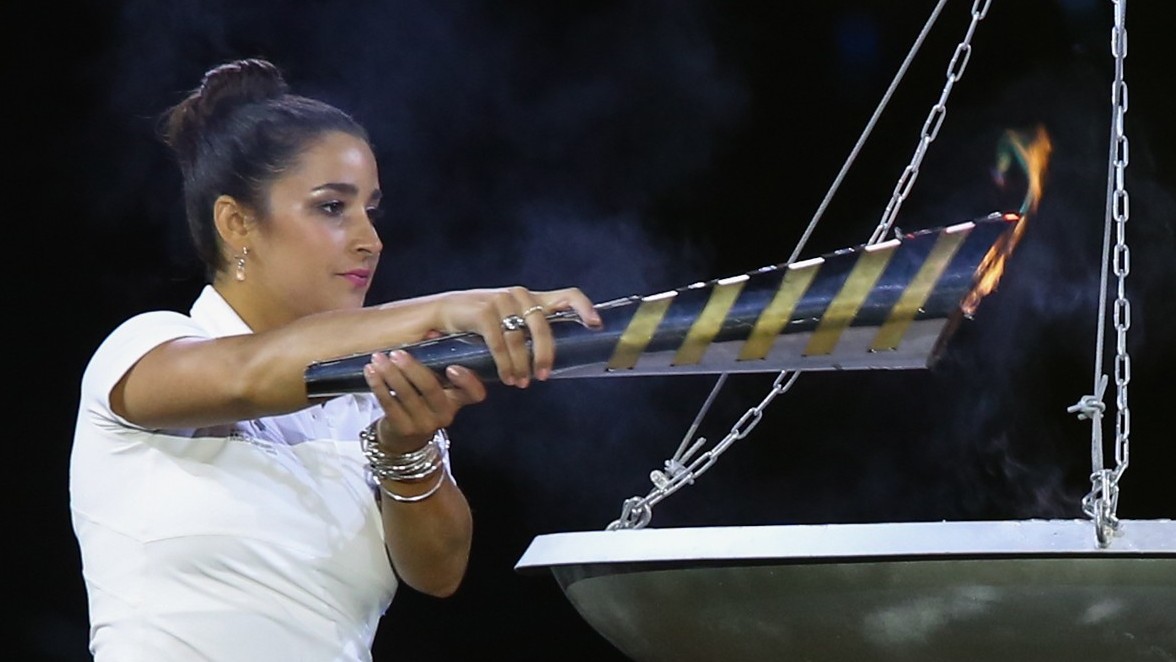 U.S. Olympic gymnast and gold medalist Aly Raisman lighting the torch during the opening ceremony of the 19th Maccabiah Games at Jerusalem's Teddy Stadium, July 19, 2013. (Yonatan Sindel/Flash90/JTA)