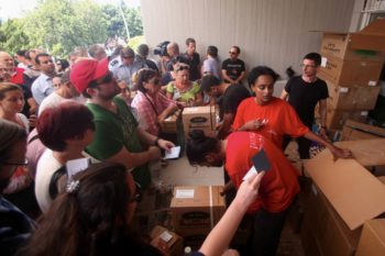 Israelis waiting to receive gas masks at a distribution center in Tel Aviv, August 28, 2013. (Roni Schutzer/Flash90)