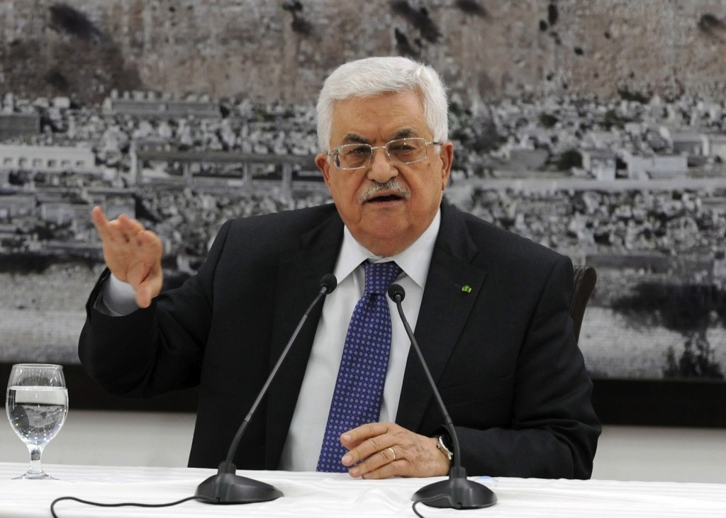 Palestinian Authority President Mahmoud Abbas meets with journalists in Ramallah on April 22, 2014, a day before his Fatah faction signed a reconciliation agreement with the militant group Hamas. (Palestinian Press Office via Getty Images)