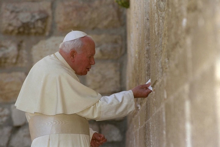 Pope John Paul II places a letter between the stones of Jerusalem's Western Wall on March 26, 2000. (Amos Ben Gershom/Israel Government Press Office via Getty Images)