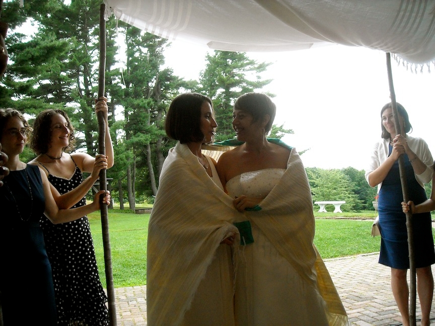 Idit Klein, right, the executive director of Keshet, married Jordan Namerow under a chuppah at their 2011 wedding in Massachusetts that was officiated by two rabbis. (Courtesy of Idit Klein)