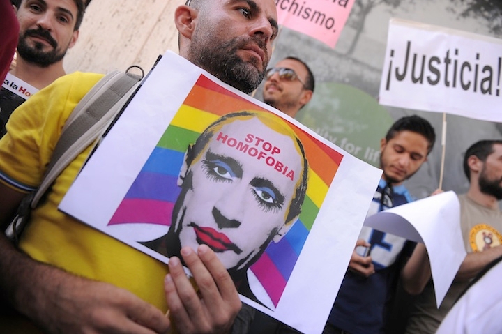 A man holds a sketch showing Russian President Vladimir Putin wearing lipstick during a protest against Russian anti-gay laws outside the Russian embassy on Aug. 23, 2013 in Madrid, Spain. (Denis Doyle/Getty Images)