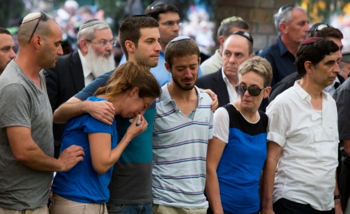 The family of Lt. Hadar Goldin mourning at his funeral at the military cemetery in Kfar Saba, Israel, Aug. 3, 2014.