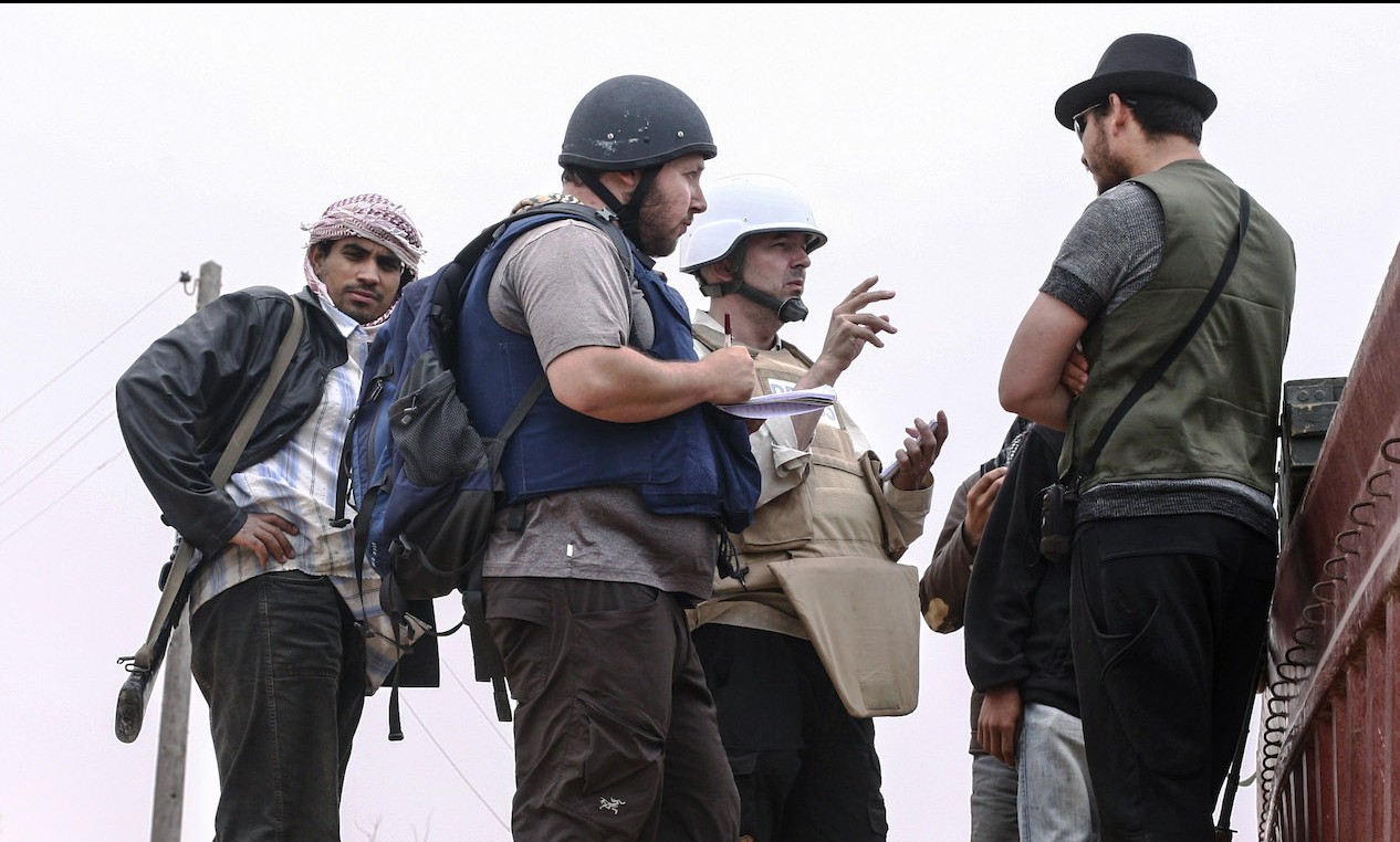 In this handout image made available by the photographer, American journalist Steven Sotloff, center with black helmet, talks to Libyan rebels on the Al Dafniya front line, about 15 miles from Misrata, Libya, June 2, 2011. Sotloff was beheaded last September nearly a year after being kidnapped in Syria. (Etienne de Malglaive via Getty Images)