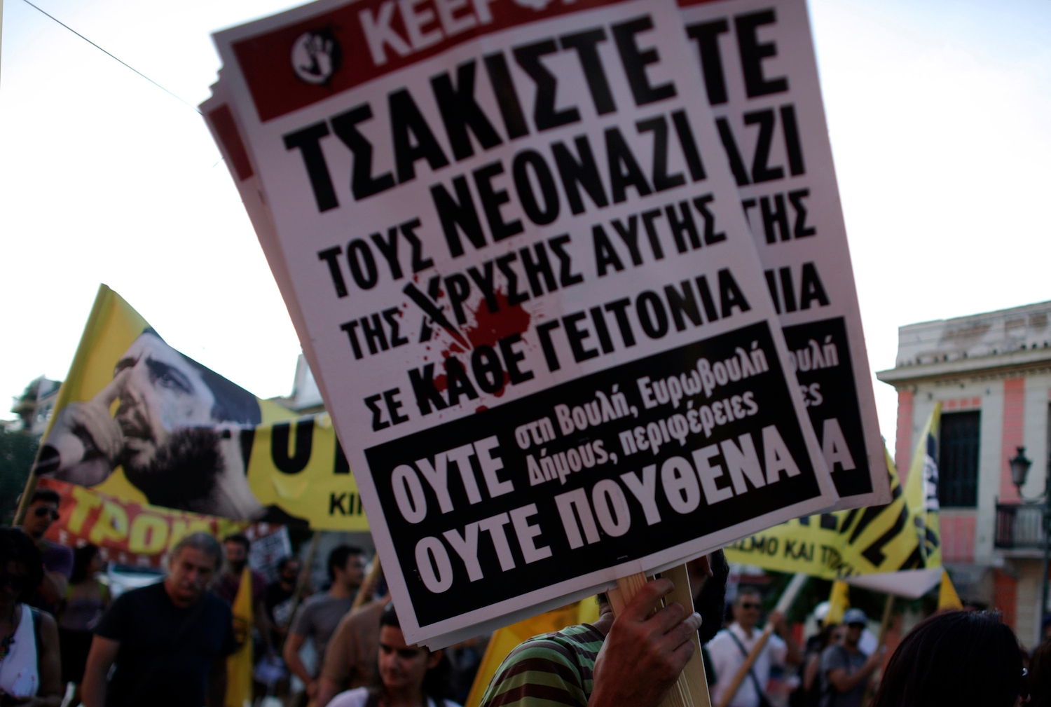 Anti-fascist protesters hold a banner in front of Athens municipal amphitheater during a swearing-in ceremony, Aug. 29, 2014. Jailed spokesman of Greece’s extreme right Golden Party Kasidiaris has been granted a short leave from prison to take part is swearing ceremony on Athens’ new city council, after the party won 16 percent of the capital’s vote in May municipal elections. Neo-Nazi Golden Dawn party has 9 of its 18 lawmakers currently in prison, awaiting trial for alleged criminal activity. (Milos Bicanski/Getty Images)