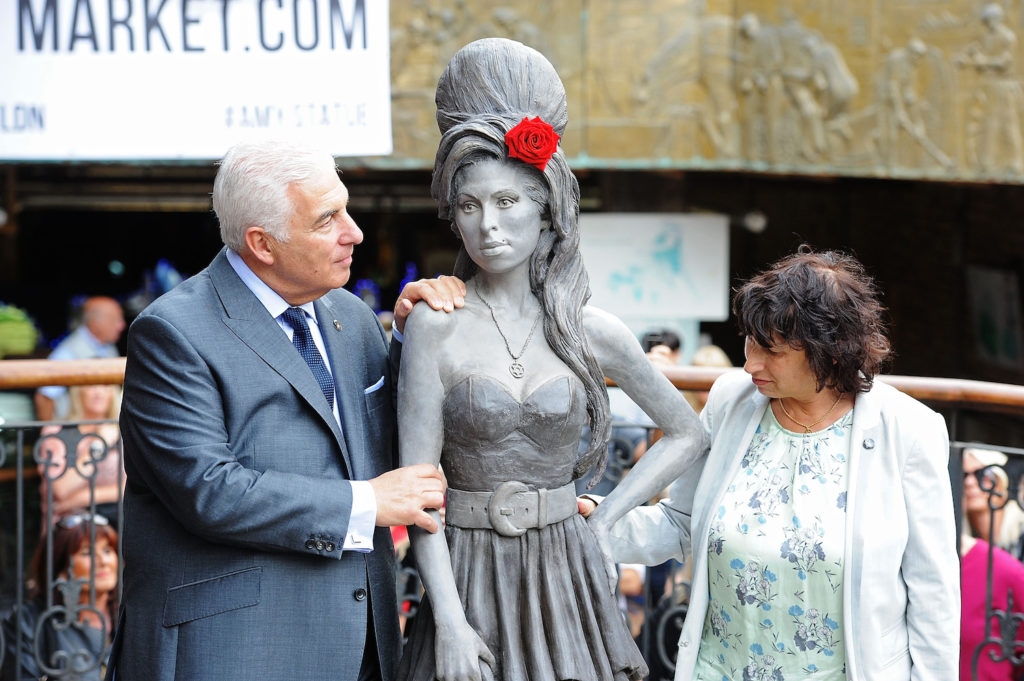 Mitch Winehouse and Janis Winehouse pose as a statue of the late Amy Winehouse is unveiled in Camden Town on Sept. 14, 2014 in London. (Dave Hogan/Getty Images)