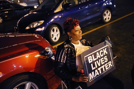 A protester at a vigil for 18-year-old Michael Brown across the street from the police station in Ferguson, Mo., Oct. 20, 2014. (Scott Olson/Getty Images) 