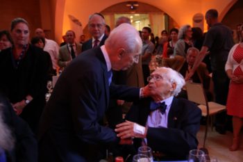 Then-Israeli President Shimon Peres, standing, greets Ralph Goldman at a salute for the former American Jewish Joint Distribution Committee leader's 100th birthday in 2014. (Courtesy JDC)