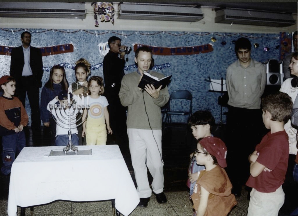 Men, women and children celebrate Hanukkah in Cuba. (Courtesy of JDC Archives) 
