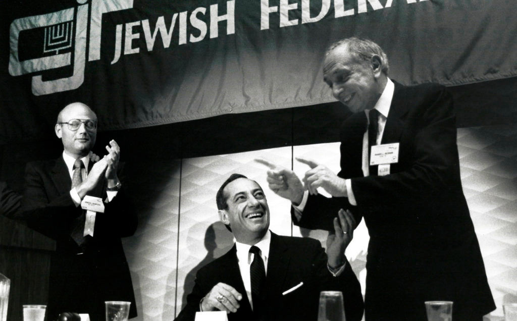 New York Governor Mario Cuomo, seated, was a featured speaker at the 1988, 57th General Assembly of the Council of Jewish Federations held in New Orleans. Showing their appreciation of the Governor's comments are CJF President Mandell L. Berman of Detroit, right, and Daniel S. Shapiro of New York. Nov. 1988. (Robert A. Cumins)