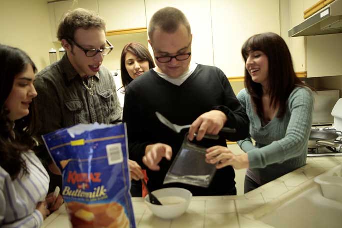 Advance LA residents cook together in their dorm. (Help Group)