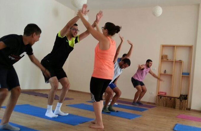 Yoga practitioners at Beit Ashams in Beit Jala practice chair pose. (Courtesy of Beit Ashams) 
