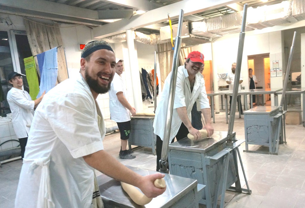 Workers at the Tiferet Matzot factory roll dough in Dnepropetrovsk on Dec. 8, 2014. (Cnaan Liphshiz/JTA)