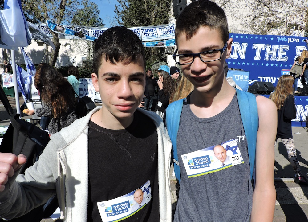 Two students at Blich High School wearing stickers showing their support for the Jewish Home party. (Ben Sales)