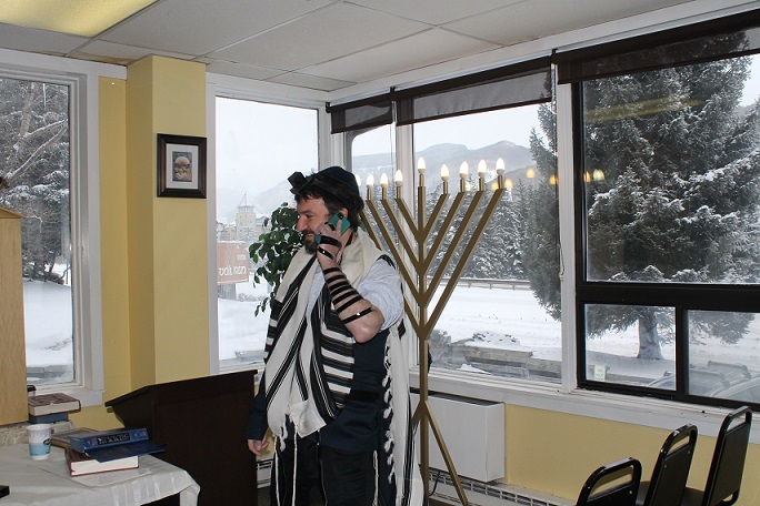 Dovid Mintz, the Chabad rabbi in Vail, Colo., works the phone trying to corral a minyan on a powdery morning at one of North America's most popular ski towns. (Uriel Heilman)