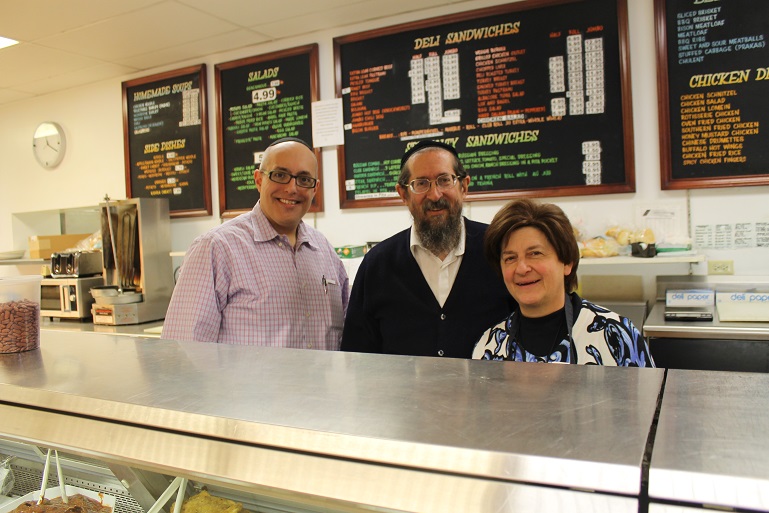 Joshua Horowitz, left, bought the East Side Kosher Deli in February 2015 from Michael and Marcy Schreiber, who had owned it for 17 years. (Uriel Heilman)