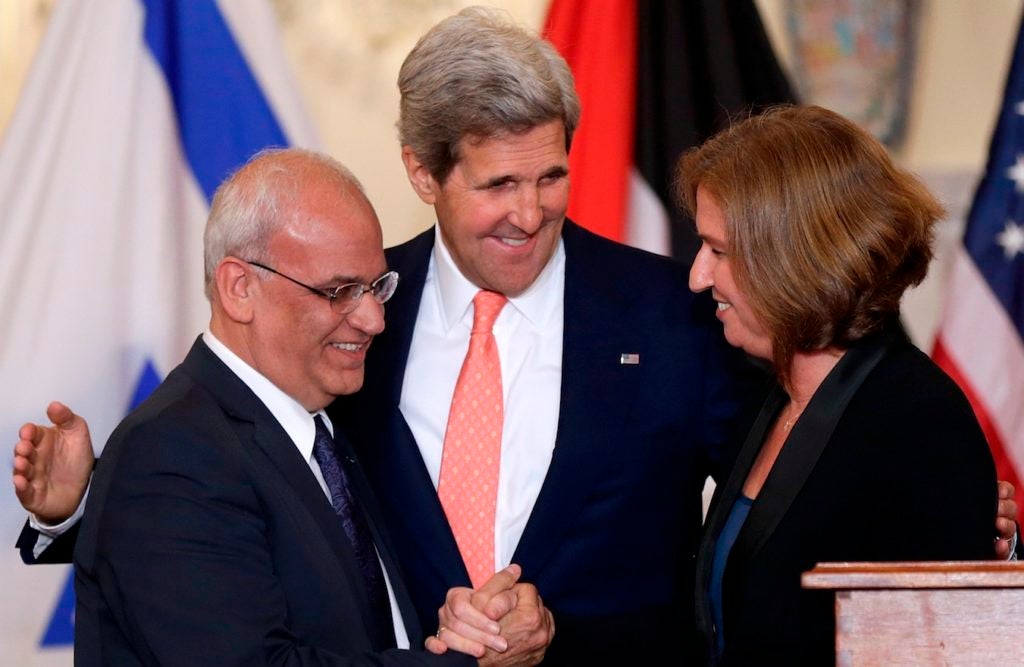 U.S. Secretary of State John Kerry, center, with Palestinian negotiator Saeb Erekat and Israeli Justice Minister Tzipi Livni at a press conference in Washington on the Middle East peace process, July 30, 2013. (Win McNamee/Getty Images)