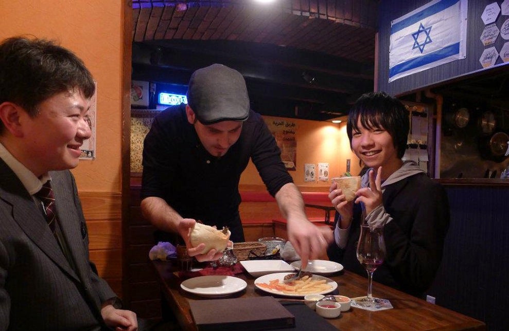Roy Somech serving patrons at a restaurant he owns in Sendai, Japan, in 2012. (Courtesy of Roy Somech)