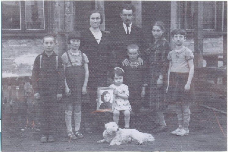 This undated photograph of the Achun family shows Yocheved holding a photograph of her Aunt Ruth, who was tormented by the presumed Holocaust deaths of these relatives. (Courtesy of Audrey Greenberg)