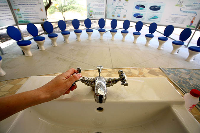 A faucet and toilets are seen in a classroom in the ecological village in Nitzana, Israel. Students there learn about desalination and on how to save water. (Chen Leopold / Flash 90)