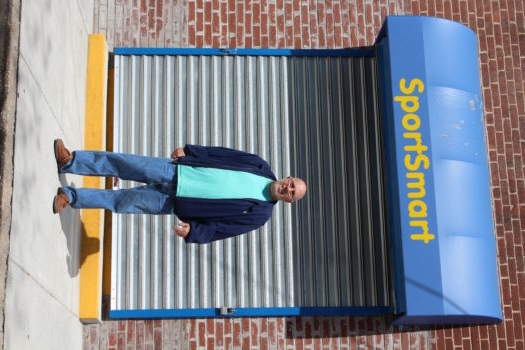 Co-owner Marc Levy stands outside SportSmart a day and a half after looters tole more than $1 million in merchandise, April 29, 2015. (Hillel Kuttler)