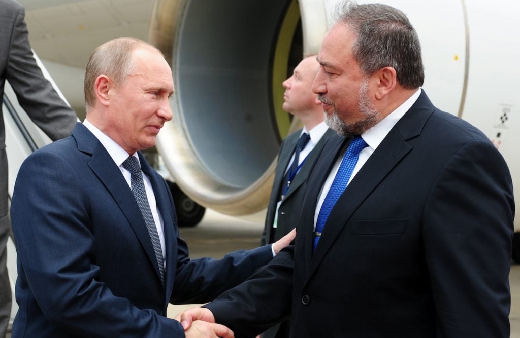 Israeli Foreign Minister Avigdor Liberman, right, receiving Russian President Vladimir Putin at Ben Gurion Airport, June 25, 2012. (GPO/Kobi Gideon)