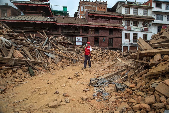 An earthquake emergency team members walks through debris from one of the UNESCO World Heritage site temples in Basantapur Durbar Square on April 28 in Kathmandu, Nepal. (Omar Havana/Getty Images)