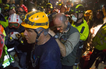 An Israeli team in the process of rescuing Krishna Devi Khadka, a young woman in her late 20s who was stuck in a hotel for five days in an air pocket covered by a body. (Mickey Noam Alon/IsraAID)