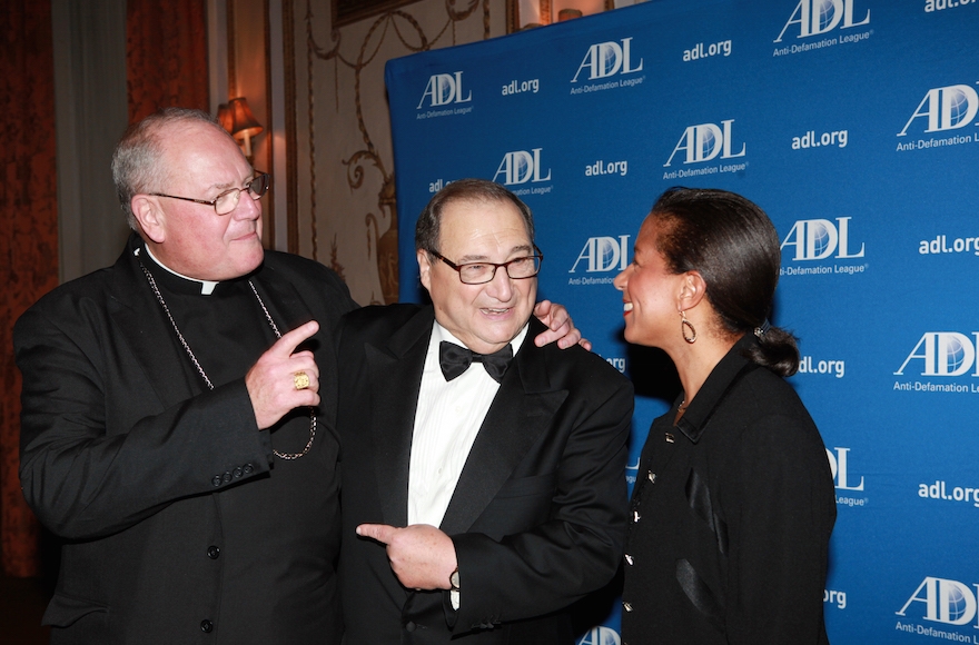 Abe Foxman (center) talks with Cardinal Timothy Dolan (left) and U.S. National Security Advisor Susan Rice (right) at an event honoring him in New York on June 17, 2015. (David Karp)