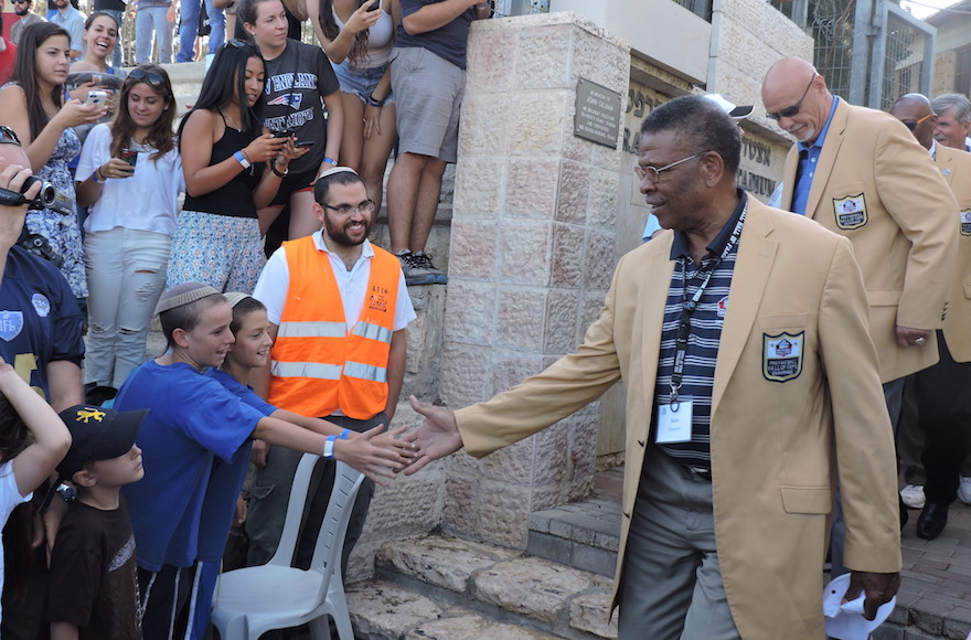 Members of the NFL Hall of Fame greet fans at Jerusalem's Kraft Stadium Sunday. (Ben Sales)