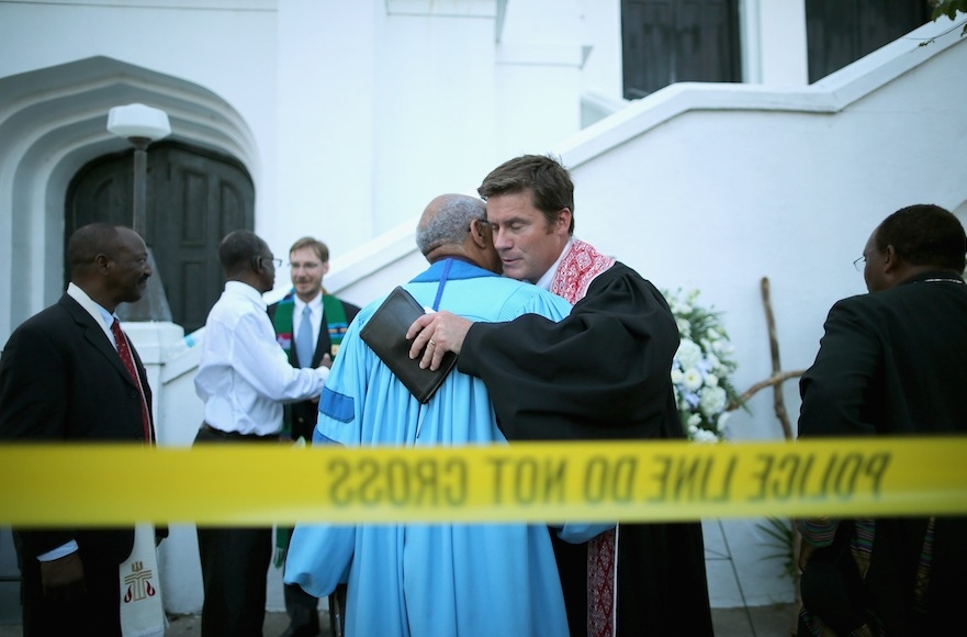 The Rev. John Hage, right, embracing the Rev. Sidney Davis outside the historic Emanuel African Methodist Episcopal Church in Charleston, S.C., June 18, 2015. (Chip Somodevilla/Getty Images)