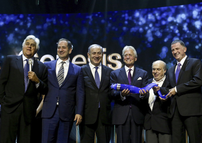 Michael Douglas, third from right, accepting the Genesis Prize in Jerusalem, June 18, 2015. From left, host Jay Leno; Stan Polovets of the Genesis Prize Foundation; Israeli Prime Minister Benjamin Netanyahu; Jewish National Fund Chairman Natan Sharansky; and Knesset Speaker Yuli Edelstein share the stage with Douglas. (Flash90 via Marc Israel Sellem/POOL).