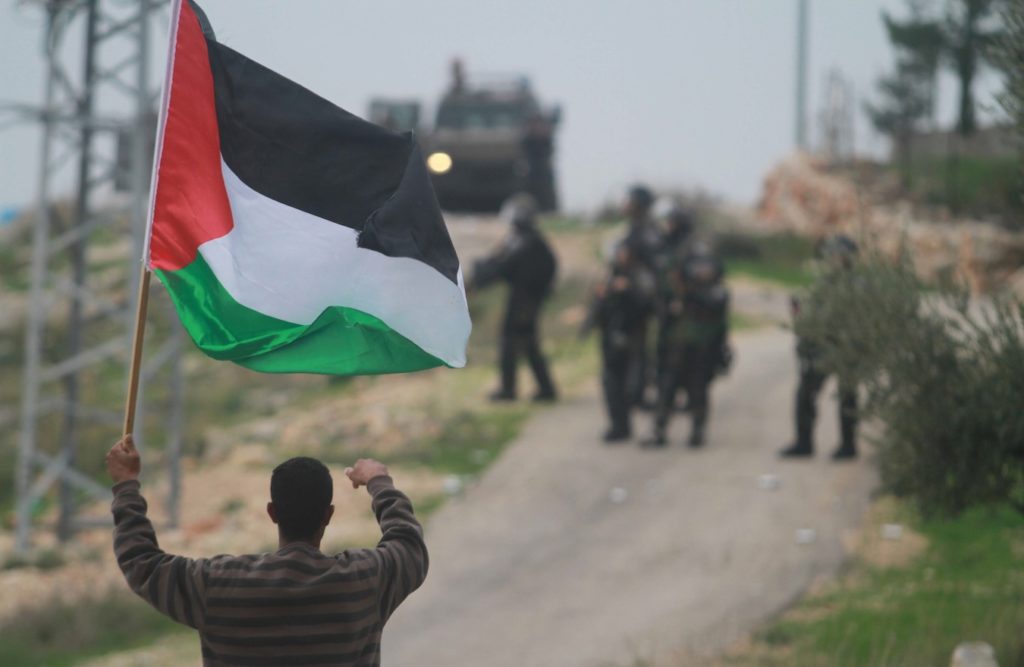 Palestinian protesters clashing with Israeli troops in the West Bank village of Bilin, Dec. 12, 2014. (STR/Flash90)