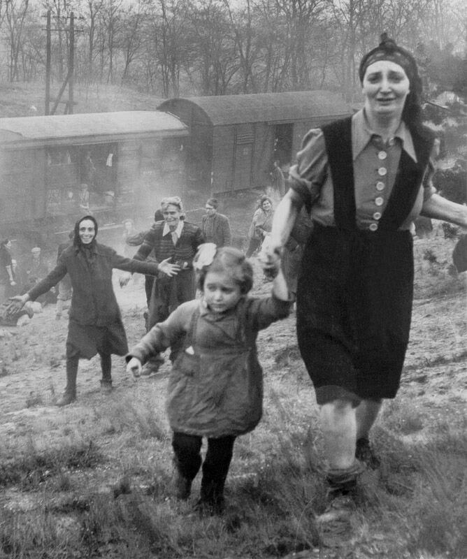 This 1945 photo of freed Bergen-Belsen inmates led to a search for the identities of the woman and little girl whose hand she is holding. (Courtesy of George Gross). 
