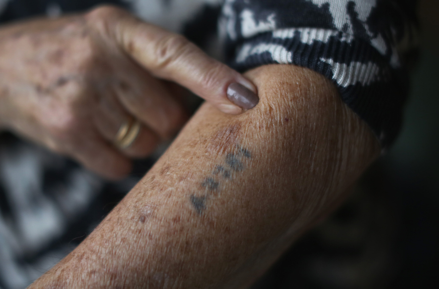 A Holocaust survivor shows her number tattoo. (Christopher Furlong/Getty Images)