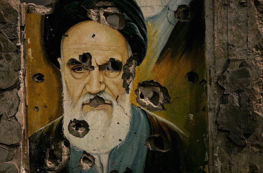 A bullet-ridden picture of Ayatollah Ali Khamenei is displayed in Lebanon in 2006. Iranian dissidents in Europe are divided on whether the nuclear deal with the West will help or hurt Iran's supreme leader. (Spencer Platt/Getty Images)