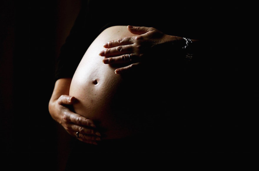A pregnant woman holds her stomach: There is more demand than supply of Jewish eggs, say egg bank officials. (Ian Waldie/Getty Images)