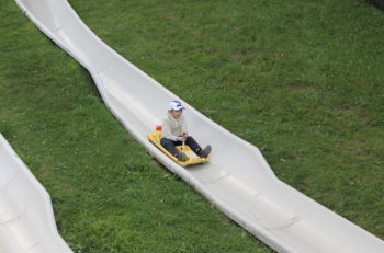 Orthodox Jewish visitors wear hats or tuck their yarmulkes into pockets to keep from losing them on the alpine slide. (Uriel Heilman)