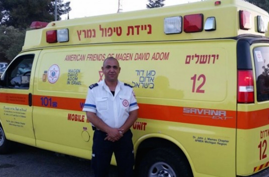 Israeli Arab Magen David Adom paramedic Ziad Dawiyat standing beside his ambulance. (Courtesy/MDA)
