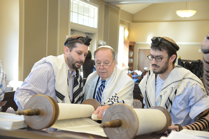 From left, Bradley Bain, Elliott Bain and Yehuda Halper read Torah at Beth Israel in Metairie, Louisiana. (Alexander Barkoff)