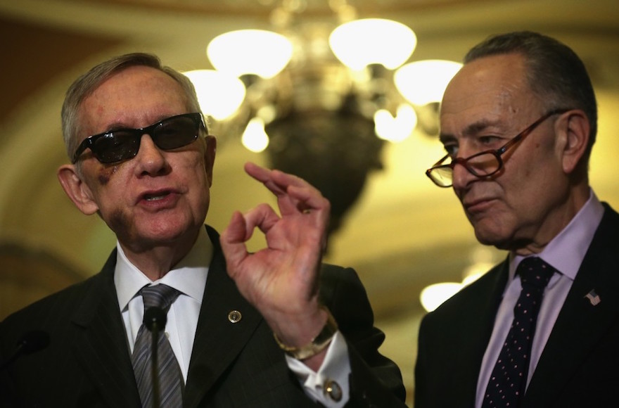 Sen. Harry Reid, left, the Senate minority leader, and his likely successor, Sen. Charles Schumer, at a news briefing in Washington, D.C., Feb. 24, 2015. Reid is supporting the Iran deal and Schumer said he will vote against it. (Alex Wong/Getty Images)
