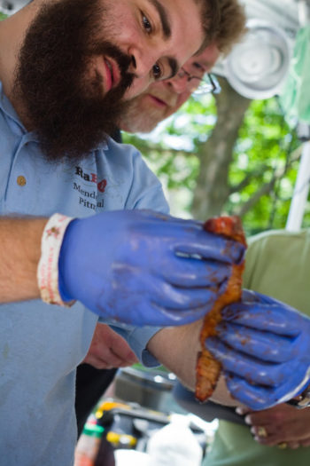 Segal and teammate Duane Dougherty check the tenderness of the rabbi's brisket at the 2014 Liberty 4th Fest BBQ Contest in Liberty, MO. (Courtesy of Mendel Segal)