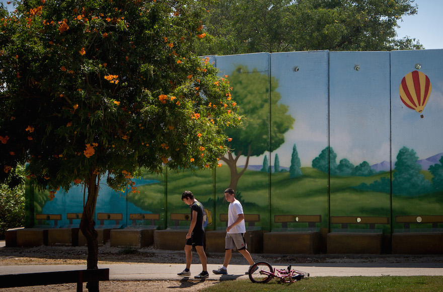 Israeli children in the southern kibbutz of Nahal Oz playing near a colorfully painted concrete shelter. (Miriam Alster/FLASH90) 