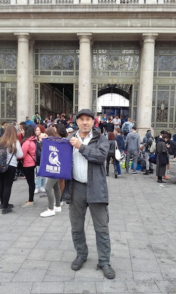 Hans Breuer holding a sign calling for an end to the deportation of migrants at a train station in Budapest, Hungary in August 2015. (Courtesy Hans Breuer)