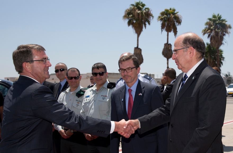 U.S. Defense Secretary Ash Carter, left, shaking hands with Israeli Defense Minister Moshe Yaalon on the tarmac before boarding a C-17 military aircraft at Ben Gurion International Airport in Tel Aviv, Israel on July 21, 2015. (Carolyn Kaster/Pool/AP Images)